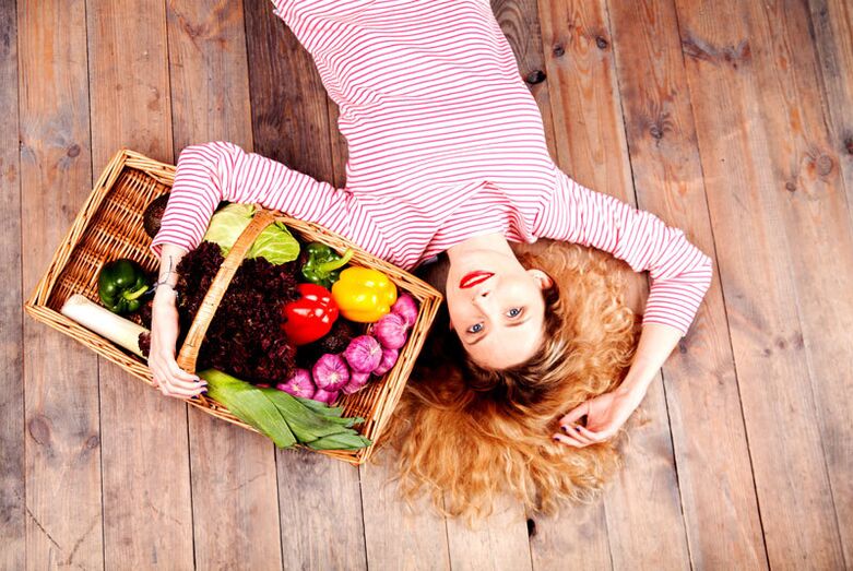 Girl with a basket of vegetables.